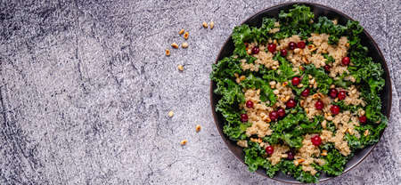 Healthy raw kale and quinoa salad with cranberry and pine nut. Top view.の写真素材