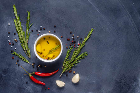 Herbs and condiments on black stone background. Top view with copy space.の写真素材