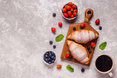 Breakfast with croissants and fresh fruits, top view.の写真素材