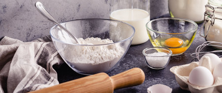 Baking background. Cooking ingredients for dough, eggs, flour, sugar, milk.
