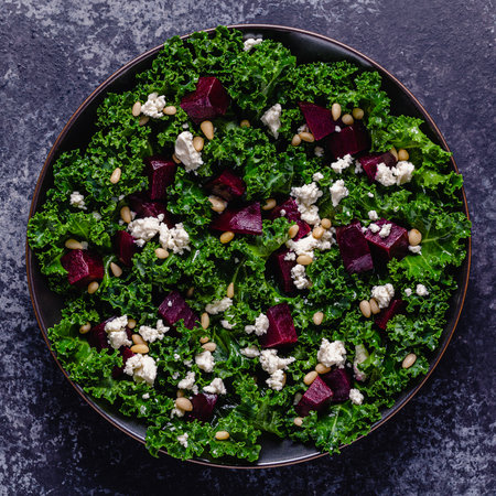 Healthy raw kale and beetroot salad with feta cheese and pine nut. Top view.の写真素材