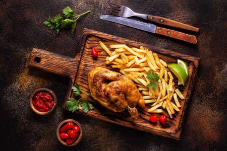 Half roasted chicken Piri Piri with french fries, top view