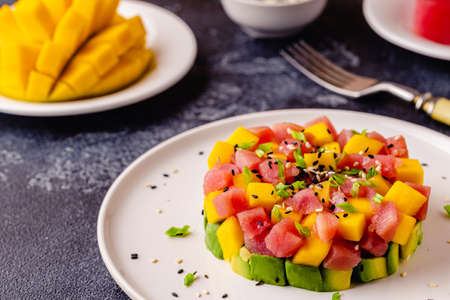 Tuna mango avocado salad tartare served with green onions and sesame seeds.の写真素材