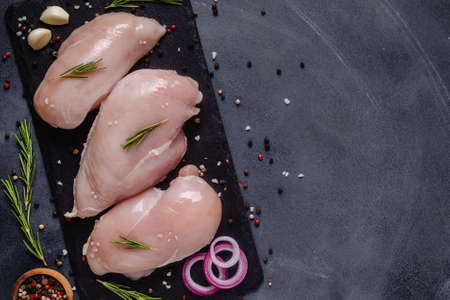 Raw chicken fillet with spices and herbs, top view.の写真素材
