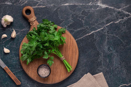 cutting board, parsley on a marble table, top viewの写真素材