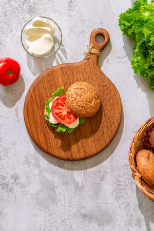 Vegetarian sandwich with cheese and tomato. Healthy vegetarian food concept, top view.