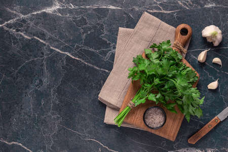 cutting board, parsley on a marble table, top viewの写真素材