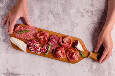 Serving board with a set of different meat snacks, top view.の写真素材