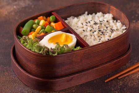 Healthy lunch in wooden japanese bento box. Balanced healthy food conceptの写真素材