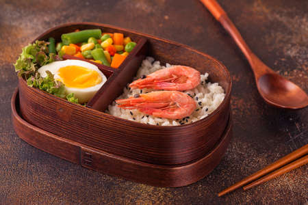 Healthy lunch in wooden japanese bento box. Balanced healthy food concept