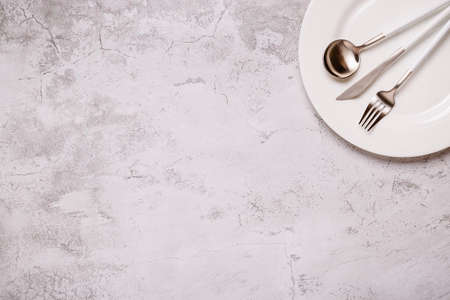 Clean empty white plate with cutlery. Copy space, mock up, top view. Concept for menu with utensil.