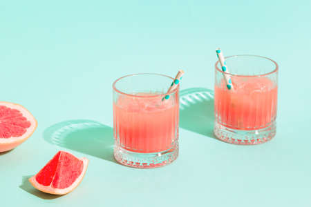 Cold lemonade / cocktail of fresh grapefruit juice, alcohol and ice cubes.の写真素材