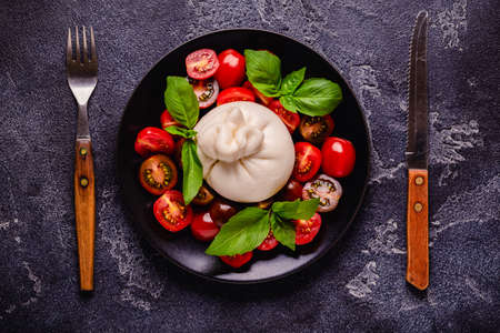Tasty delicious buratta chese with fresh tomatoes, top viewの写真素材