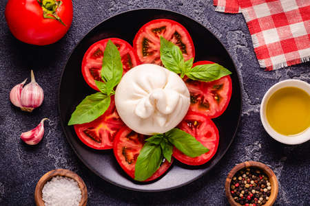 Tasty delicious buratta chese with fresh tomatoes, top viewの写真素材