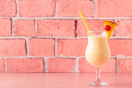 Traditional caribbean cocktail pina colada in a glass, garnished with a slice of pineapple.の写真素材
