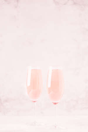 Champagne or wine in glasses on light background. Copy space.の写真素材