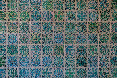 The texture of the ceramic tiles in the oriental style. Turkish ceramic tiles lined up on the wall.