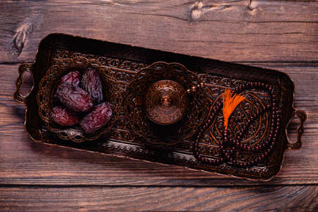 Dried dates fruit, tea and rosary. Popular fruit of Ramadan. Top view.