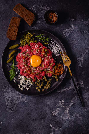 Fresh beef tartar with tasty vegetables, top view.の写真素材