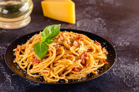 Homemade Ñarbonara pasta with pancetta, egg, hard parmesan cheese and cream sauce, selective focusの写真素材