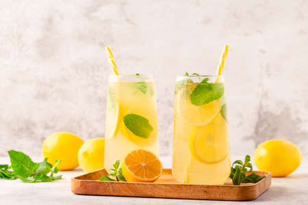 Lemonade with lemon, mint and ice cubes in glass, selective focusの写真素材