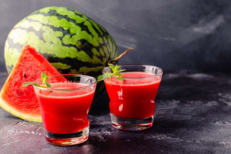 Fresh tasty delicious watermelon juice on a dark background, selective focusの写真素材