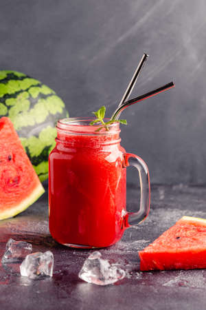 Fresh tasty delicious watermelon juice on a dark background, selective focusの写真素材
