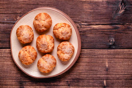 Homemade profiteroles with powdered sugar.の写真素材