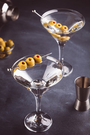 Classic Dry Martini with olives on dark stone table.の写真素材