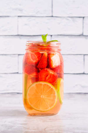 Healthy detox infused water with fruits. Refreshing summer homemade cocktail.の写真素材