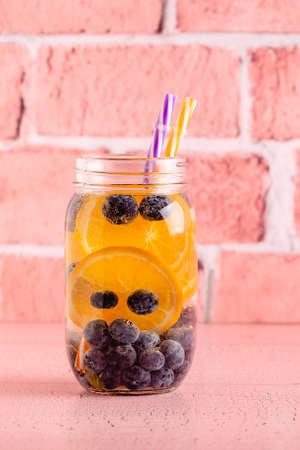 Healthy detox infused water with fruits. Refreshing summer homemade cocktail.の写真素材