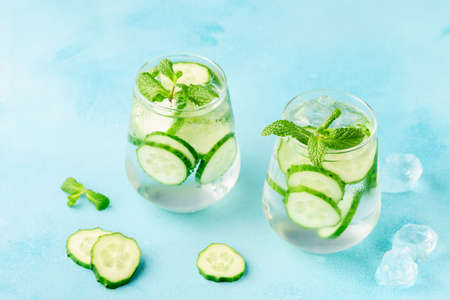 Fresh infused cucumber water on a light blue background, selective focusの写真素材