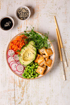 Buddha bowl asian salad with tofu cheese. Healthy vegan food, clean eating, dieting.