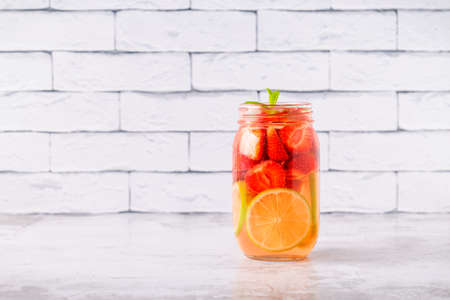 Healthy detox infused water with fruits. Refreshing summer homemade cocktail.