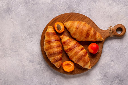 French croissants. Freshly baked croissants on a dark stone background.の写真素材