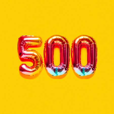 Rainbow foil balloon number, digit five hundred. top view. Colored numeral on yellow background.
