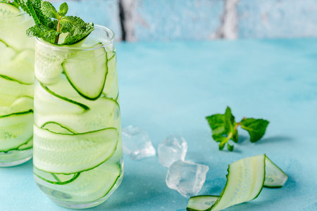 Fresh infused cucumber water on a light blue background, selective focusの写真素材