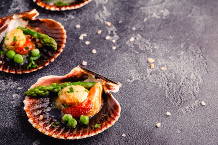 Cooked scallops with vegetables on a dark backgroundの写真素材