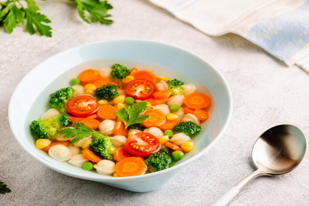 Homemade soup with mini dumplings and vegetables.の写真素材