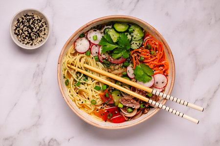 Korean Cold Noodle Soup with beef, cucumber, tomato, radish, carrot, kimchi.の写真素材