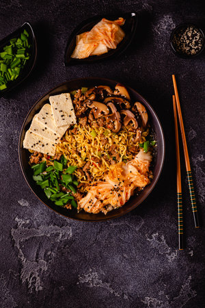 Korean style instant noodle, Shin Ramyeon with minced meat, kimchi, tofu cheese, shiitake mushrooms.の写真素材