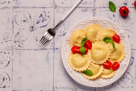 Ravioli with tomato sauce and basil on white plate.の写真素材