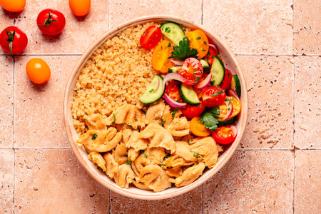 Bowl of quinoa with vegan soy meat and vegetables, top view.の写真素材