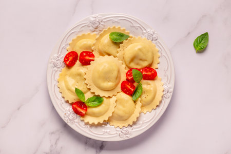 Ravioli with tomato sauce and basil on white plate.の写真素材