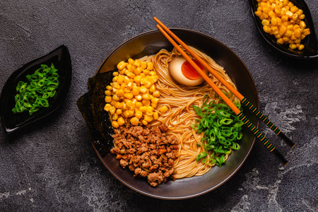 A bowl of ramen with noodles, meat and green onions, top view.の写真素材