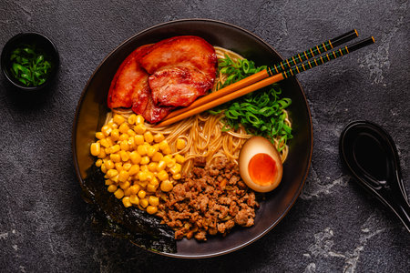 A bowl of ramen with noodles, meat and green onions, top view.の写真素材