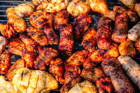 Different types of grilled meat on charcoal grill.の写真素材