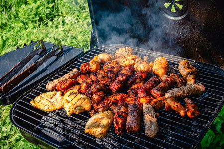 Different types of grilled meat on charcoal grill.の写真素材