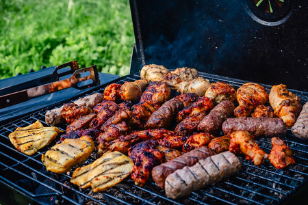 Different types of grilled meat on charcoal grill.の写真素材