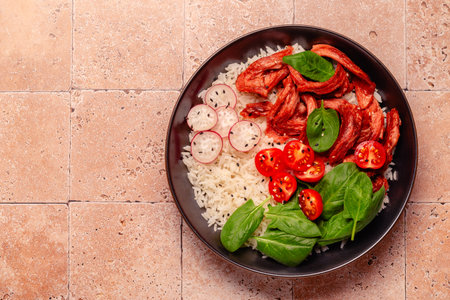 Bowl with vegan fried soy meat and vegetables served with boiled rice. Delicious healthy diet food.の写真素材